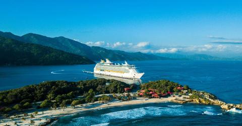 A cruise ship sits docked at a tropical location