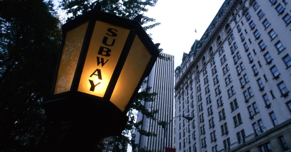 Subway platform sign on a lamppost near New York University. 