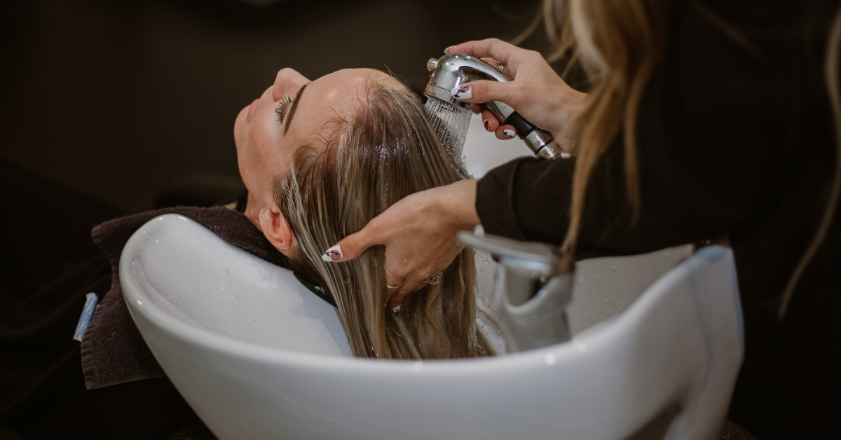 A woman gets her hair rinsed at the salon