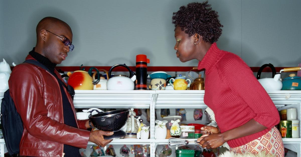 Two people shopping for household items at a thrift store. 