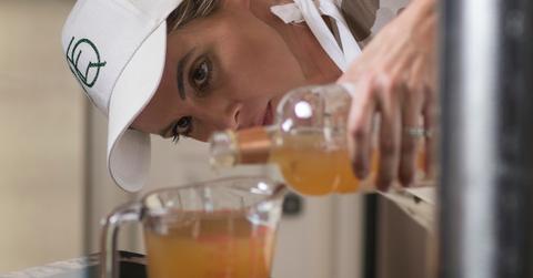 Lindsey Christianson measures organic apple cider vinegar that will be used in a batch of elderberry syrup