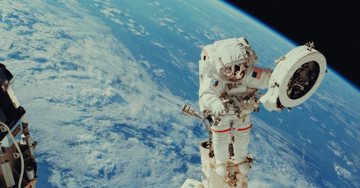 An astronaut works on fixing a fixture on the International Space Station