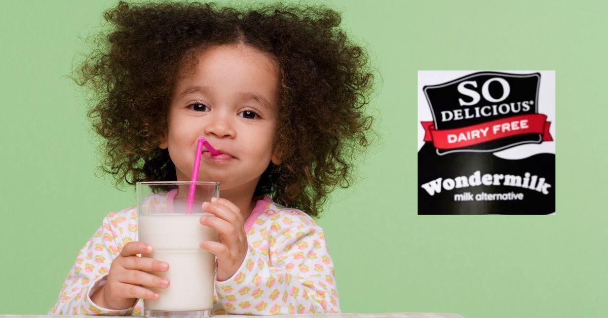 Little girl drinking milk alternative. 