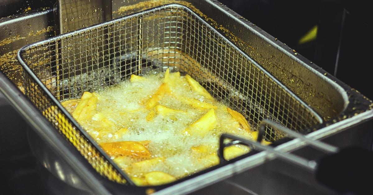 French fries being fried in oil. 