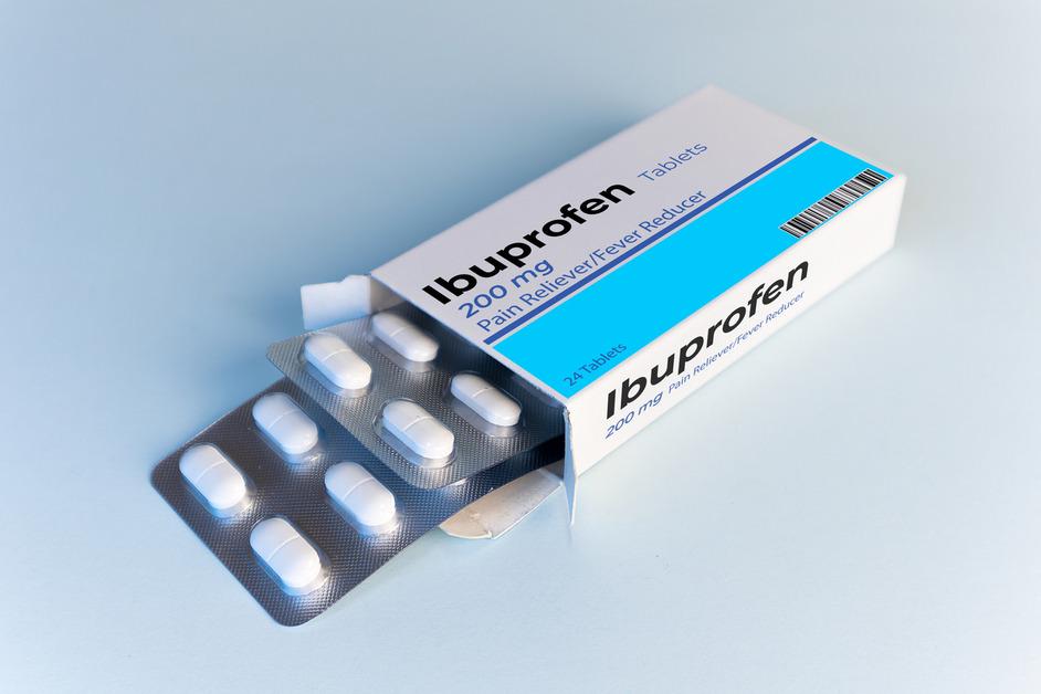 A pack of ibuprofen sits on a counter. 