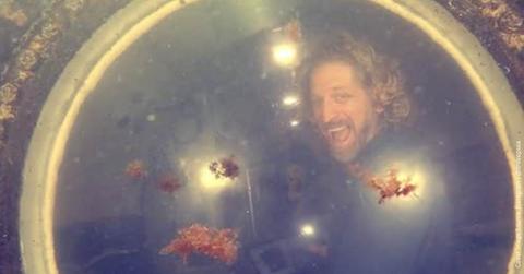 Doctor Deep Sea cheers and peers through the window of an underwater lodge (Cover Image Source: Instagram | @drdeepsea)