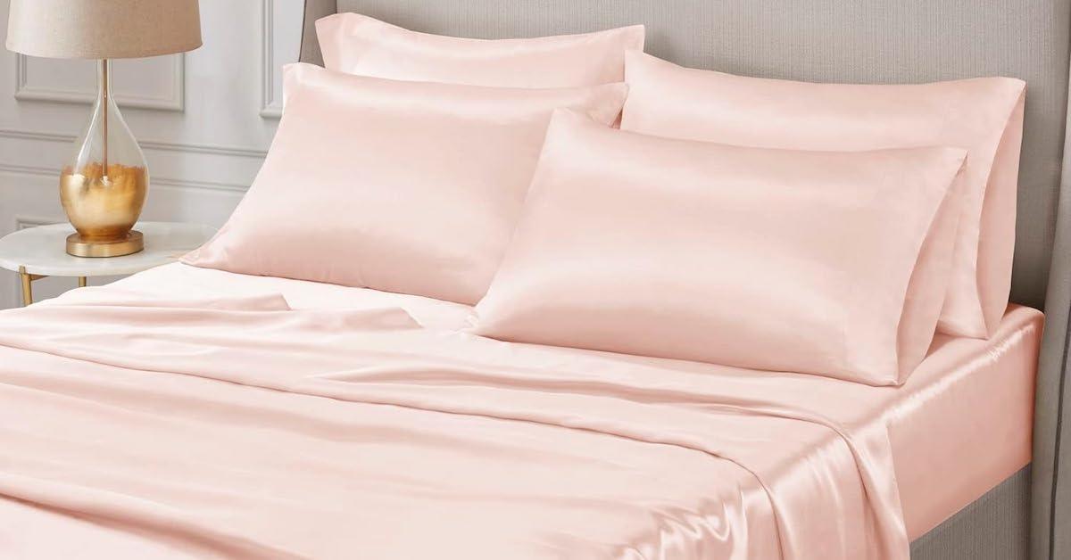 Bed made with pink silky sheet