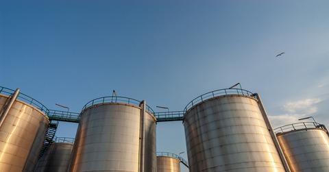 Low angle view of storage tanks taken during sunset.