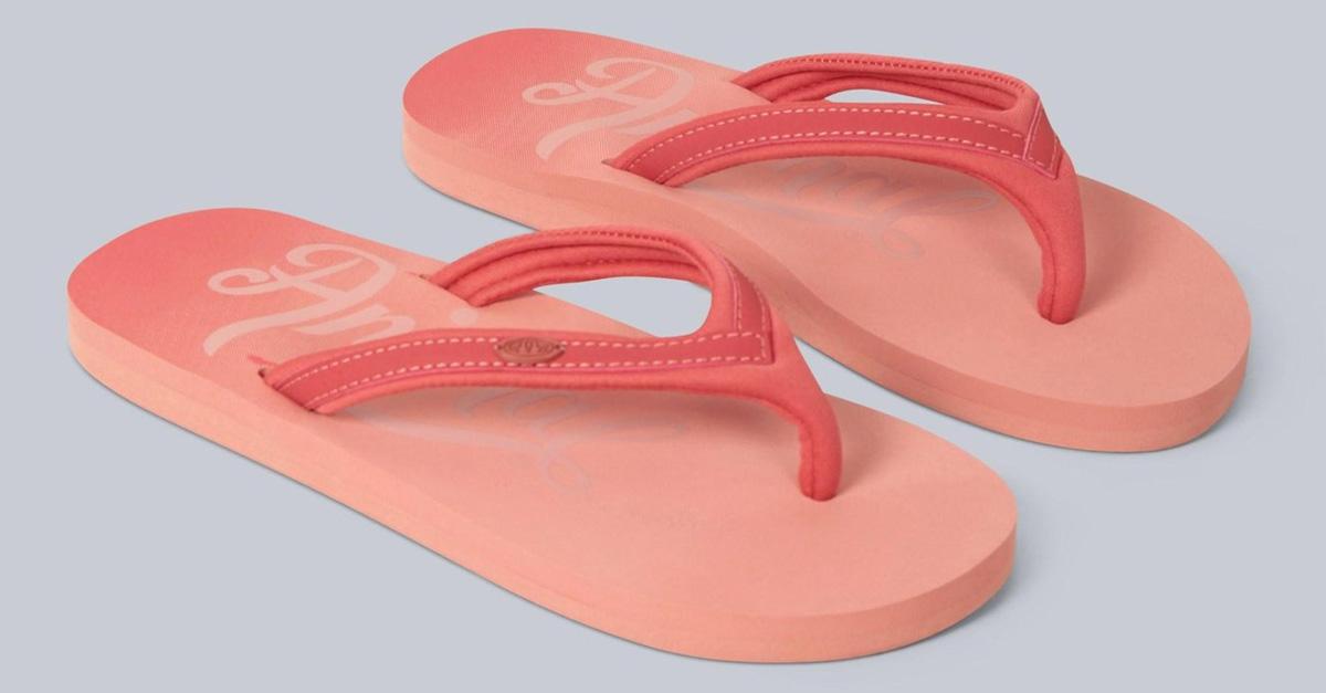 coral colored flip flops for women on grey background