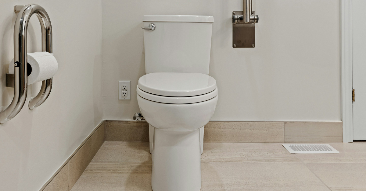A white toilet sits in a white room