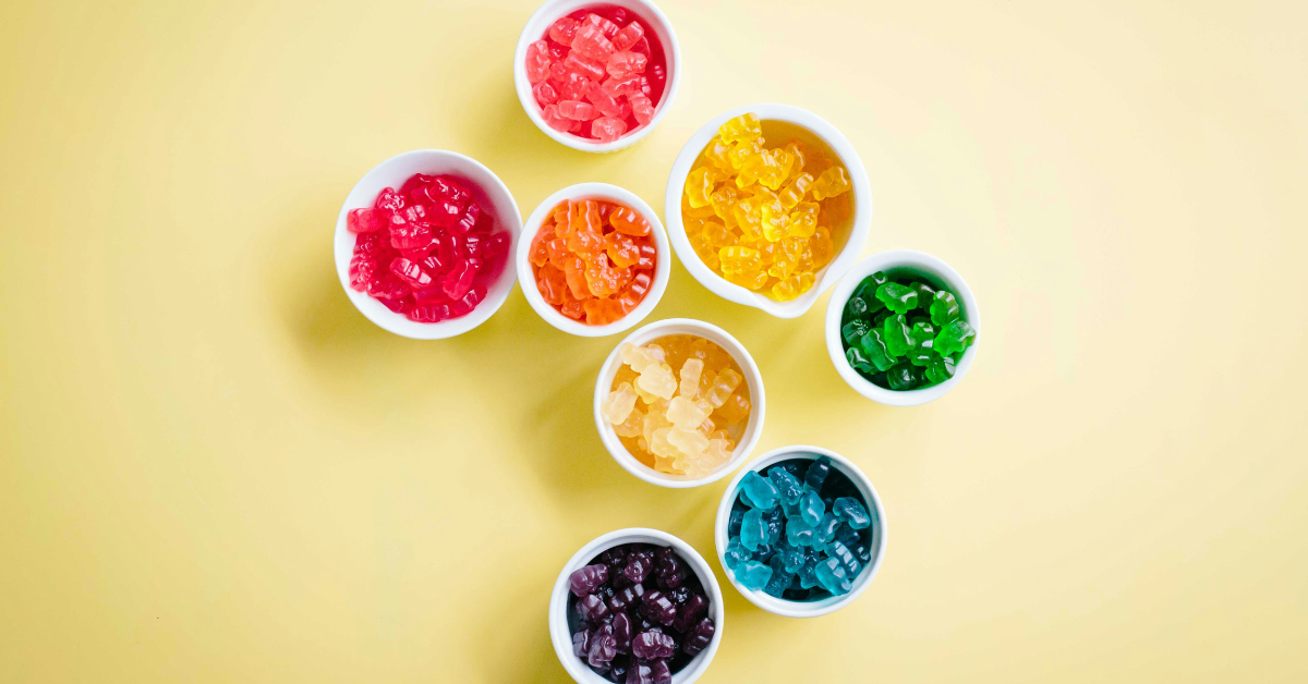 Cups of gummy bears sorted by color