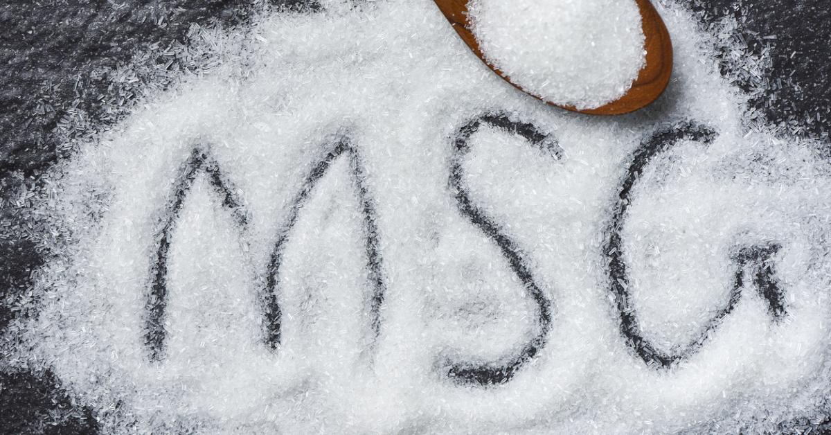 photo of the letters "MSG" drawn into monosodium glutamate granules on a dark surface 