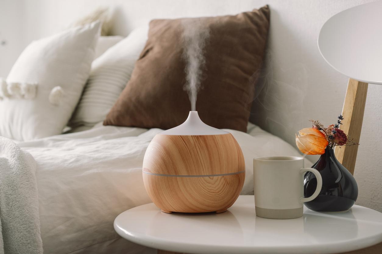 An essential oil diffuser on a nightstand