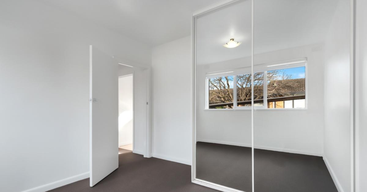 Ceiling-high mirrors on a bedroom closet. 