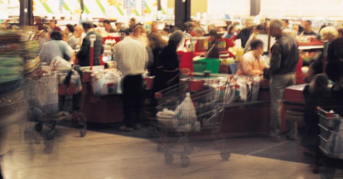 Blurry photograph of a supermarket interior.