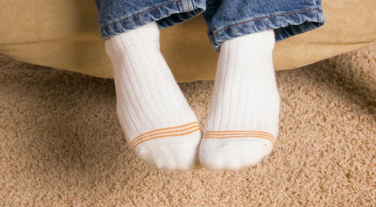 Feet in socks on carpet