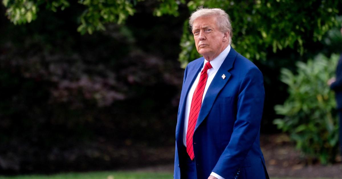 Donald Trump walks across the White House lawn
