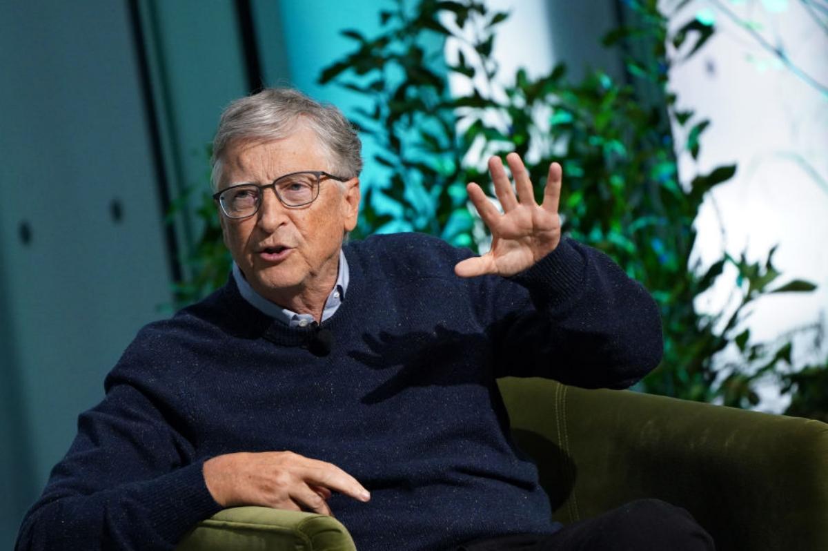 Bill Gates talking with one hand held up