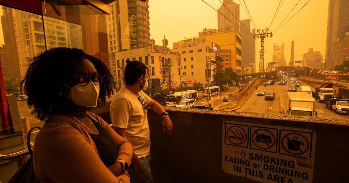 New Yorkers wearing masks amid haze from Canadian fires.