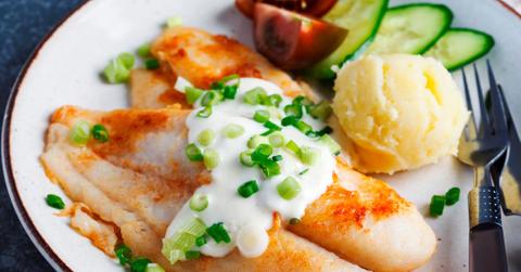 Fried swai fish with sauce. mashed potatoes, and vegetables.