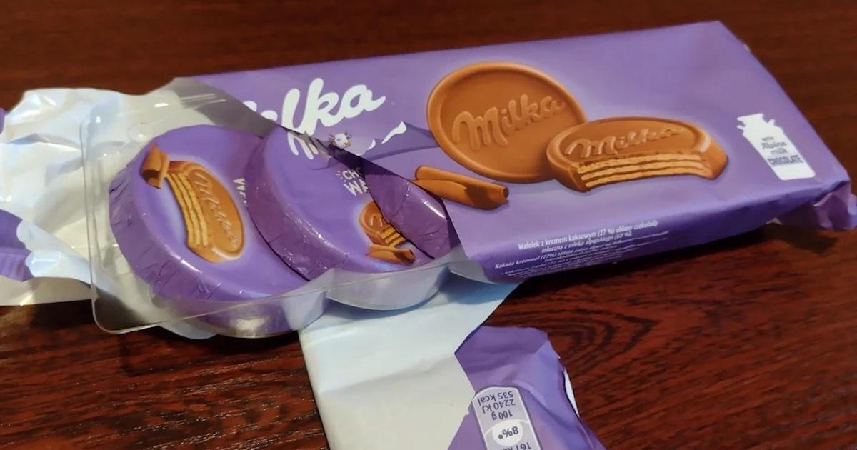 An open package of Milka chocolates, featuring individually-wrapped chocolates 