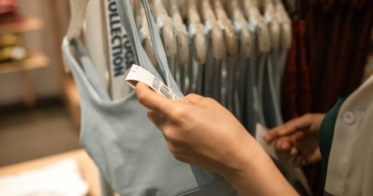 Woman checking a laundry symbol tag on a garment. (Representative Cover Image Source: Pexels | RDNE Stock Project)