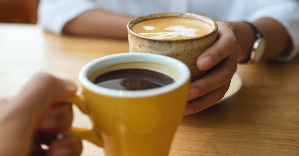 Closeup of a young couple drinking coffee together in a café