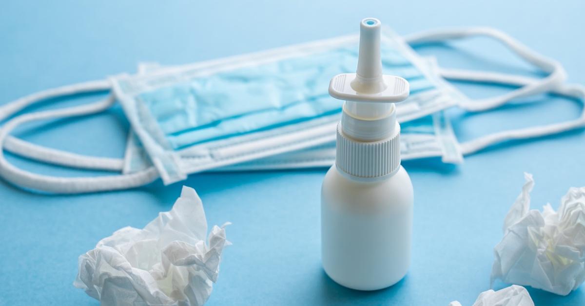 Photograph of nasal spray, tissues, masks.