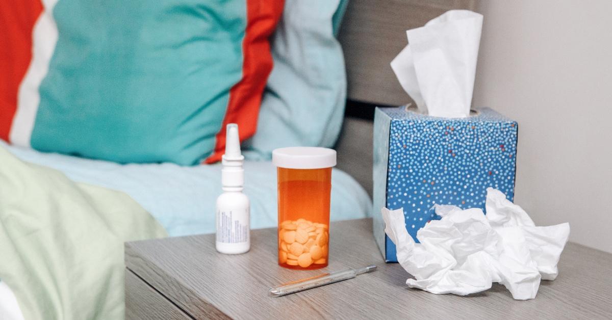 Decongestants on a bedside table with tissues