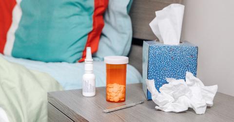 Decongestants on a bedside table with tissues