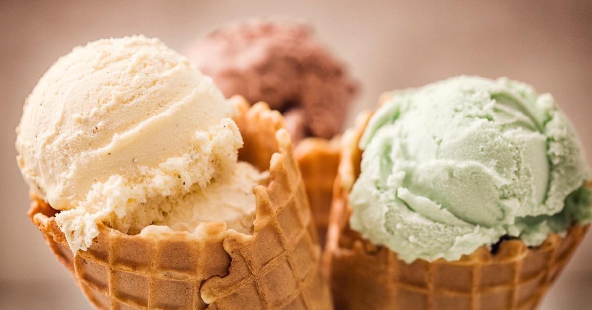 Close-up photo of three types of ice cream: vanilla, chocolate and pistachio. 