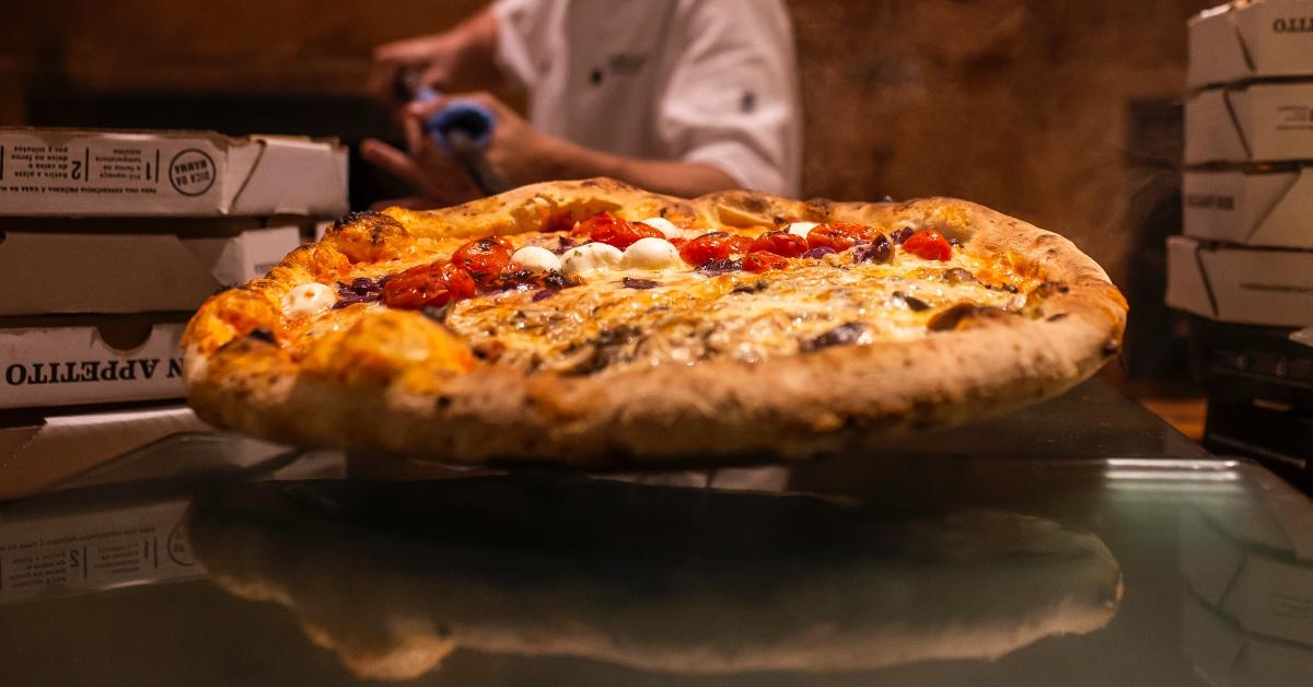 Pizza coming out of the oven.