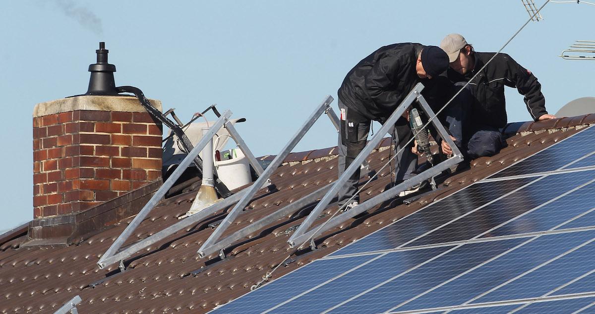 Technicians installing solar panels