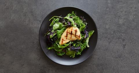 Lab-grown chicken on a bed of lettuce.