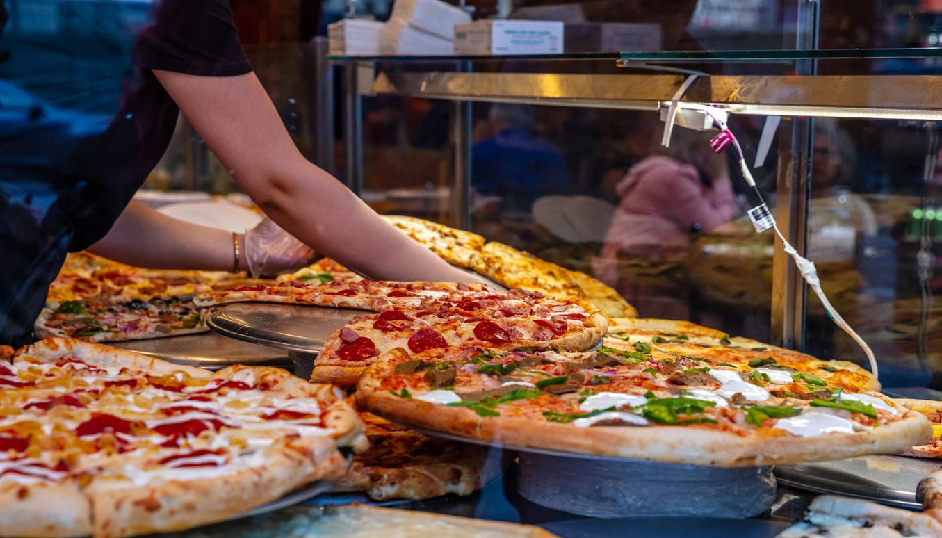 Various pizza options on display at a casual restaurant.