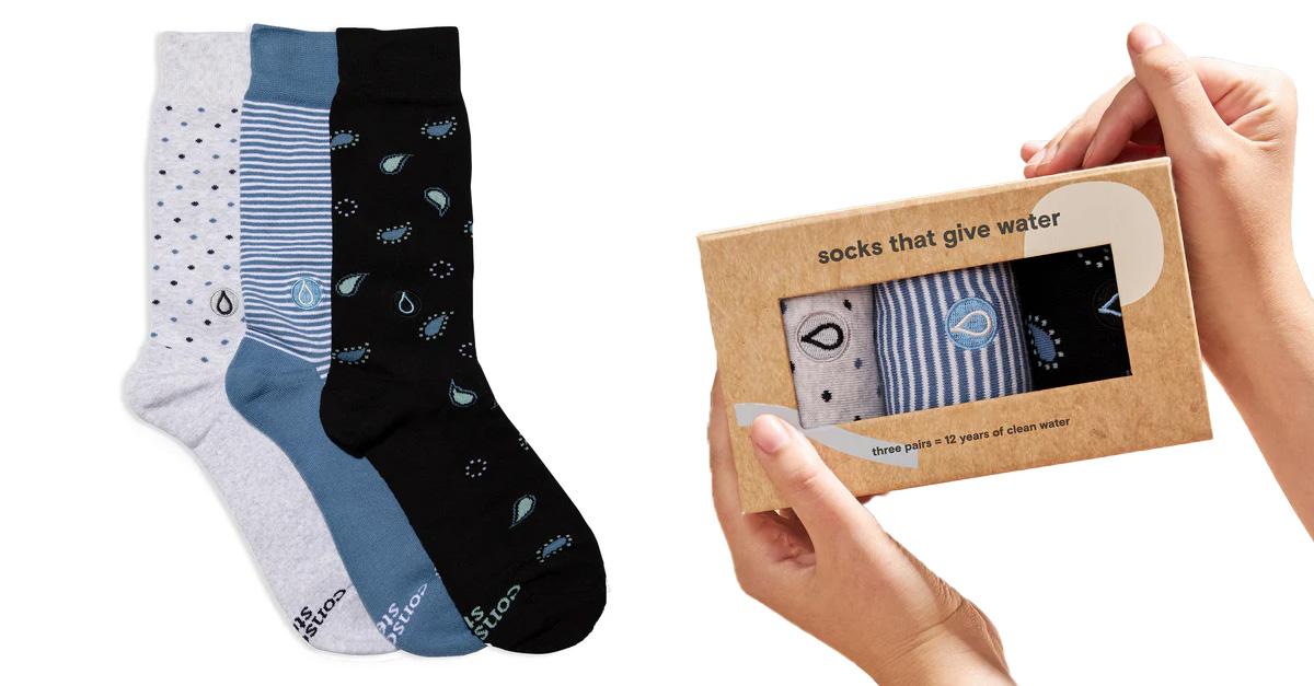 three pairs of water-themed socks in neutral colors, and hands holding those socks in a cardboard gift box