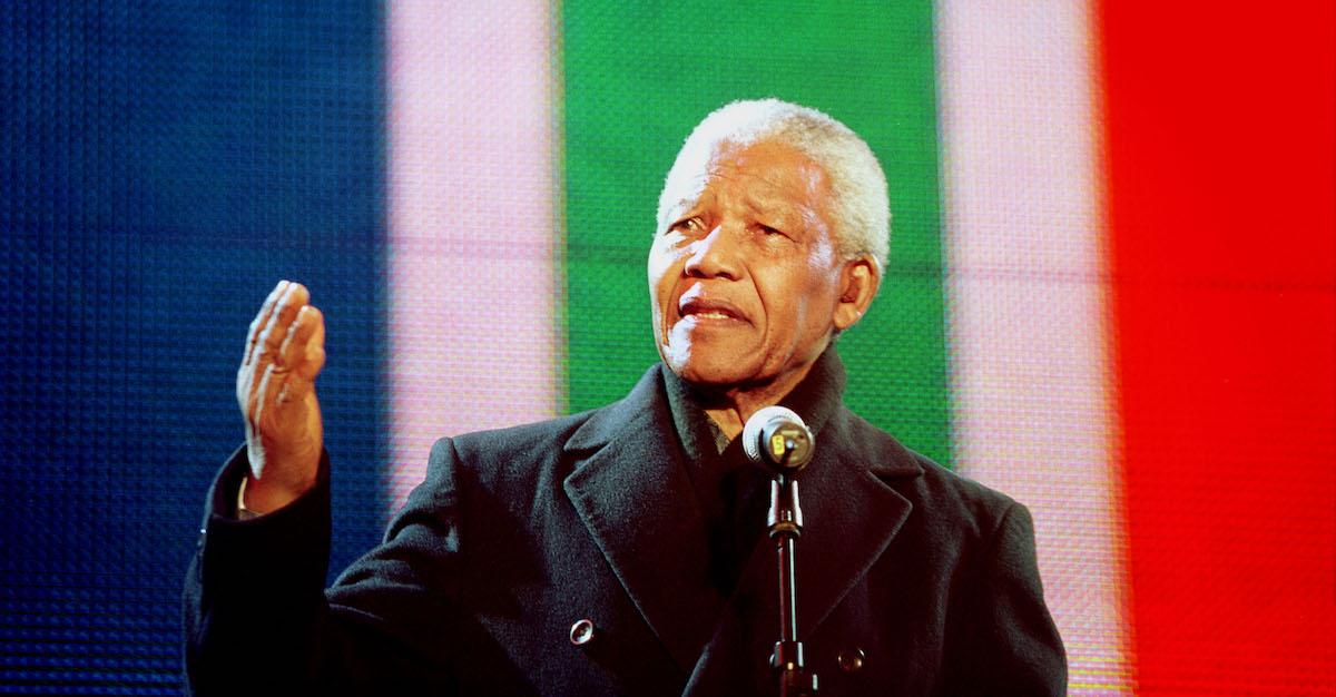 Nelson Mandela speaks into a microphone